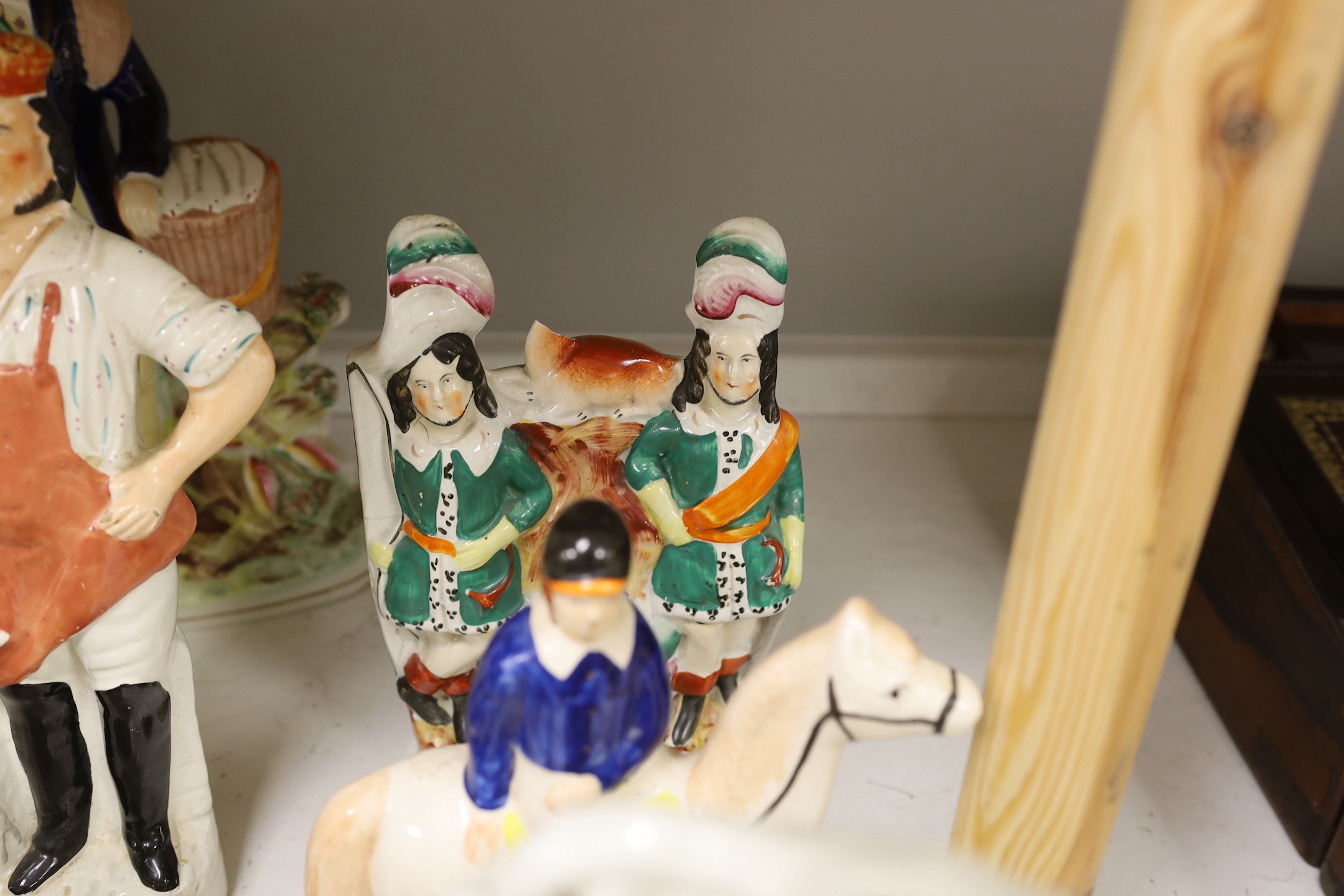 A group of Staffordshire pottery and porcellaneous figures and groups, The tallest 42 cm
